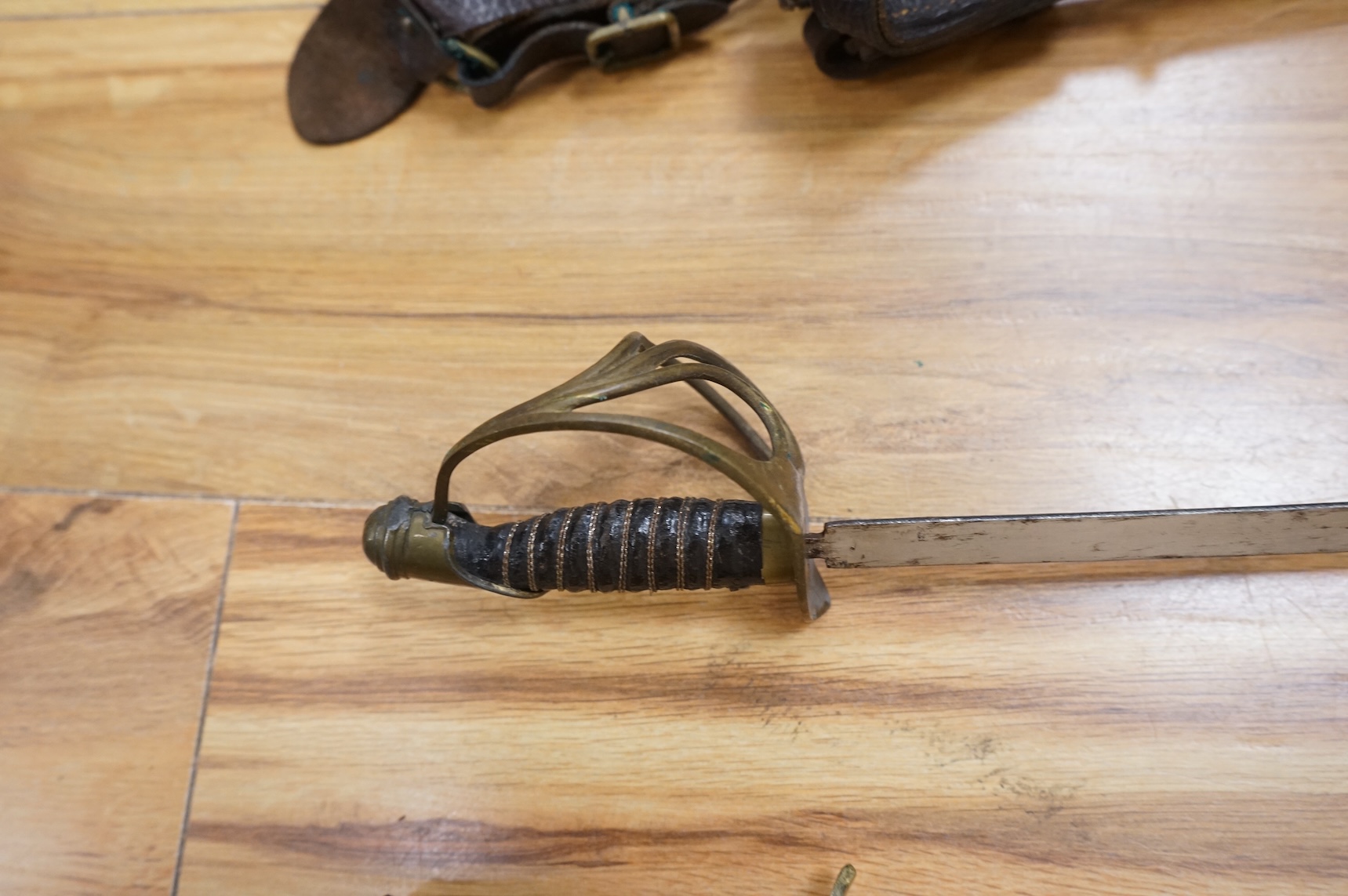 Two early 20th century Imperial German child’s swords with leather scabbards and hangers, blades 45.5cm